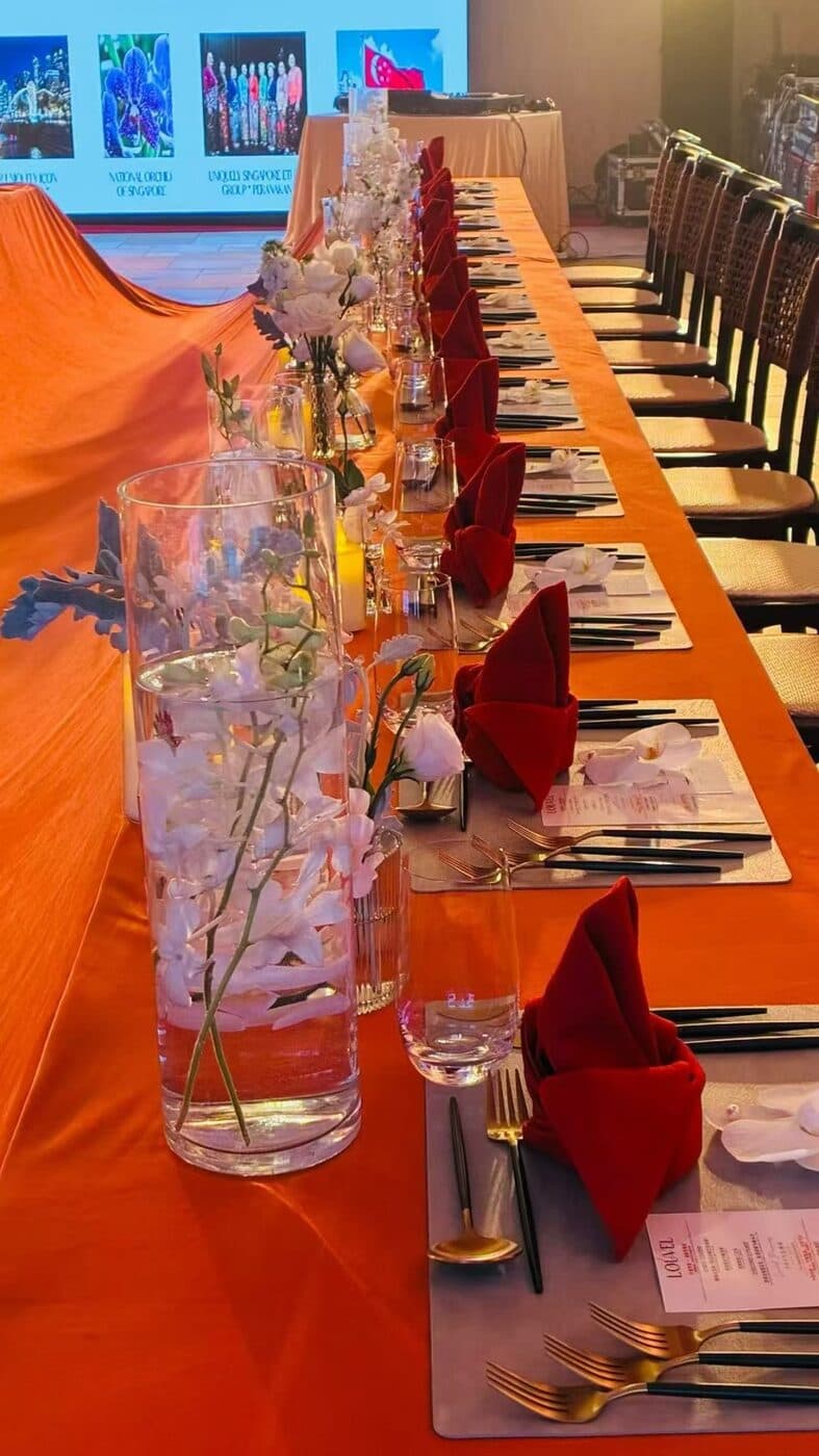 The long Tok Panjang table set with orchids and candlelight